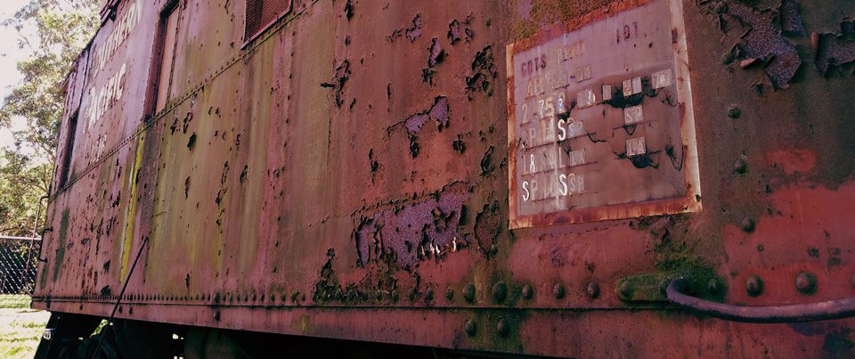 A rusted train car with numbers on it.